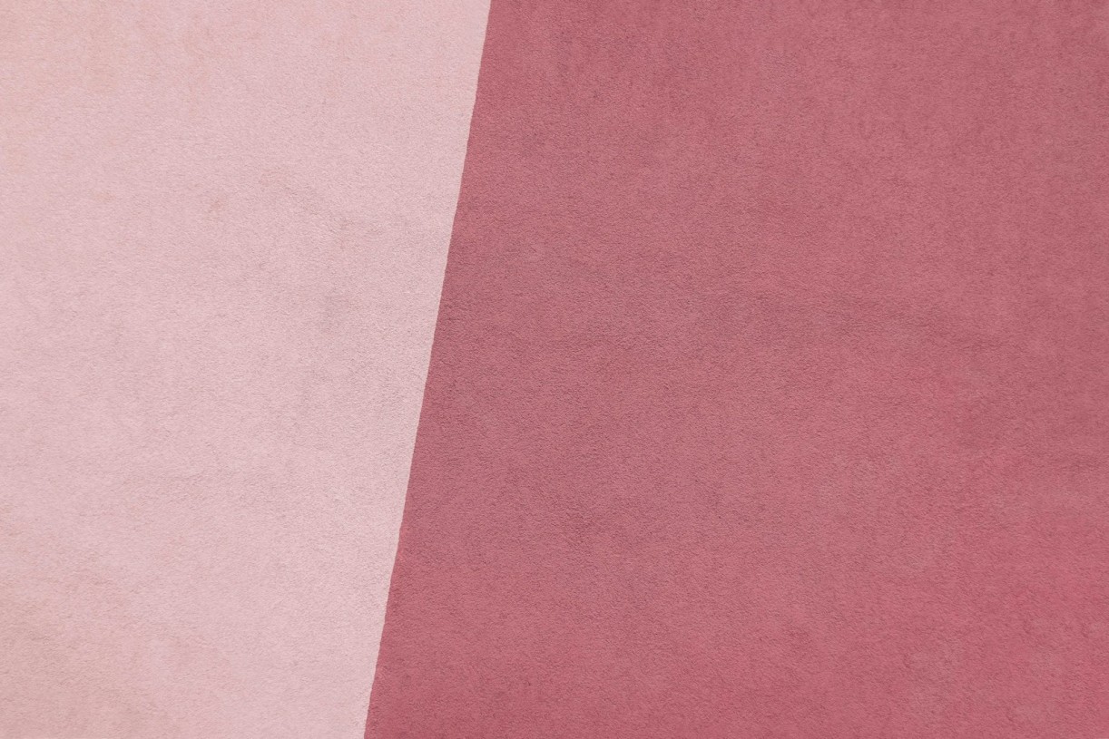 a close up of a pink and white background